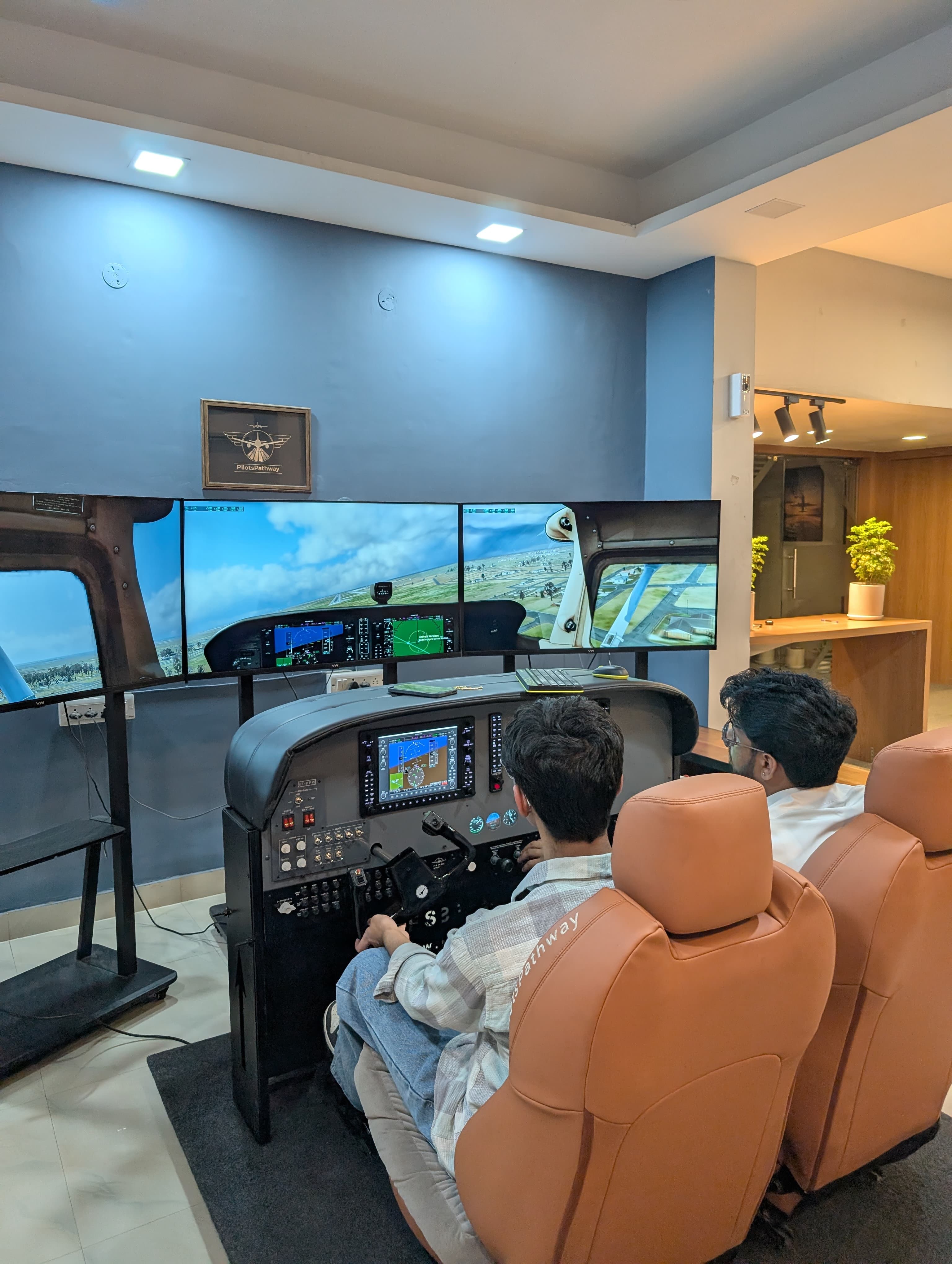 PilotsPathway mentor counseling an aspiring pilot in modern aviation facility